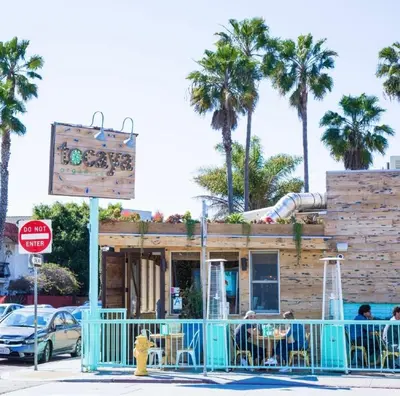 a restaurant on a street with palm trees at Drift & Dream - Opulent 1BR Marina Escape in Los Angeles