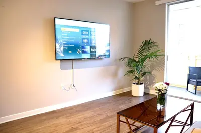 a living room with a flat screen tv on the wall at Santa Monica Place with Free Parking in Los Angeles