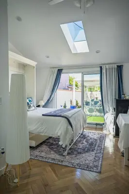 a bedroom with a bed and a large window at Beach House by LA Coast in Torrance