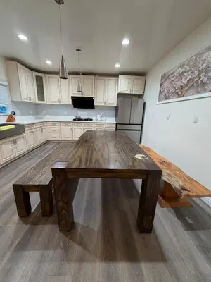 a wooden table in the middle of a kitchen at Cozy 2-Bedroom Retreat Home in East Los Angeles in Hacienda Heights
