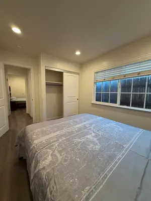 a bedroom with a large bed and a window at Cozy 2-Bedroom Retreat Home in East Los Angeles in Hacienda Heights