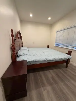 a bedroom with a bed and a desk and a window at Cozy 2-Bedroom Retreat Home in East Los Angeles in Hacienda Heights