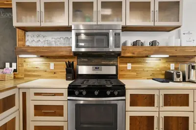 a kitchen with a stove and a microwave at Ursa Major Lodge | Walk to Lake & Village | Pet Friendly Retreat in Big Bear Lake