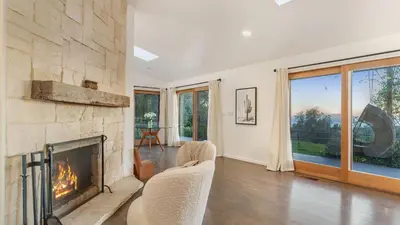 a living room with a stone fireplace and chairs at The Malibu Ranch Retreat by AvanStay Malibu Escape • Valley Views Near Zuma The Ranch Malibu in Malibu
