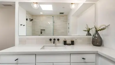 a white bathroom with a sink and a mirror at The Malibu Ranch Retreat by AvanStay Malibu Escape • Valley Views Near Zuma The Ranch Malibu in Malibu