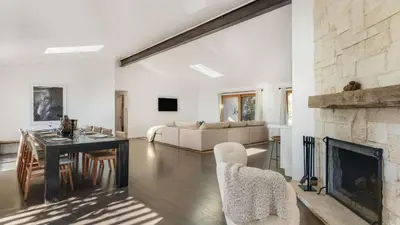 a living room with a fireplace and a table and chairs at The Malibu Ranch Retreat by AvanStay Malibu Escape • Valley Views Near Zuma The Ranch Malibu in Malibu