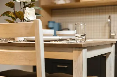 a wooden table with a glass of water on it at Fabulous and Spacious 2 level LOFT with Pool GyM Parking in Los Angeles