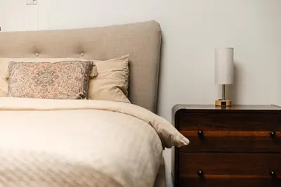 a bedroom with a bed and a nightstand with a lamp at Fabulous and Spacious 2 level LOFT with Pool GyM Parking in Los Angeles