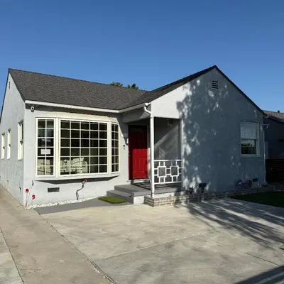 a house with a red door and a driveway at Cozy House in Hewitt