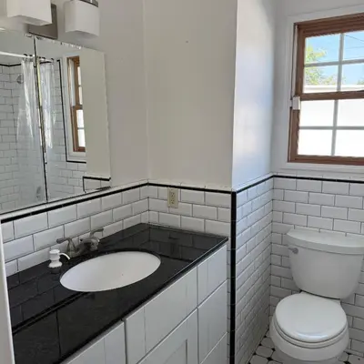 a white bathroom with a sink and a toilet at Cozy House in Hewitt