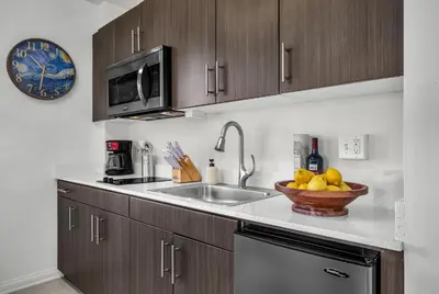 a kitchen with a sink and a bowl of fruit at Grand Studio On The Promenade Free Parking in Los Angeles
