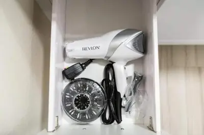 a hair dryer and a fan in a cabinet at Spacious 2 bed 2 bath, Pool, Hottub, Wifi, 24 hr Fitness, Parking in Los Angeles