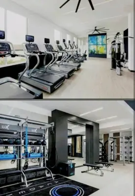 a gym with a row of treadmills at Spacious 2 bed 2 bath, Pool, Hottub, Wifi, 24 hr Fitness, Parking in Los Angeles