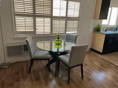 a dining room table with chairs and a vase on it at Charming 1 bedroom apt in Beverly Hills in Los Angeles