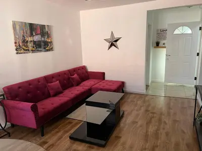 a living room with a red couch and a star on the wall at Charming 1 bedroom apt in Beverly Hills in Los Angeles