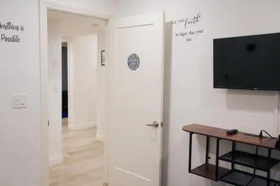 a room with a door with a tv and a table at The Warmwood Retreat in Los Angeles