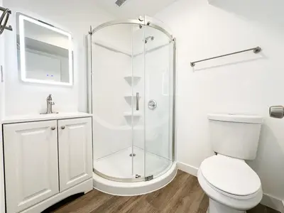 a white bathroom with a shower and a toilet at The 1443 in Los Angeles