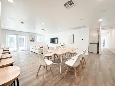a white living room with a table and chairs at The 1443 in Los Angeles