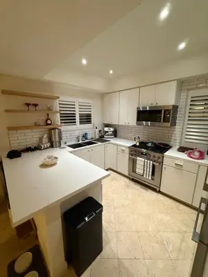 a kitchen with white cabinets and a white counter top at Venice beach in Los Angeles