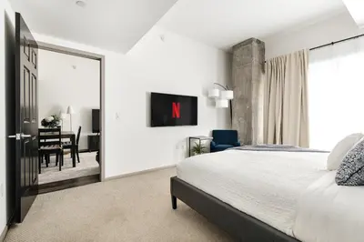 a bedroom with a large bed and a dining room at Brilliant 2BD condo in Los Angeles