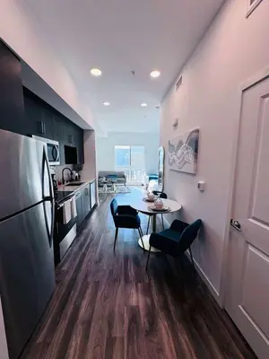a kitchen with a table and chairs and a refrigerator at The Central Apartment at Hollywood in Los Angeles