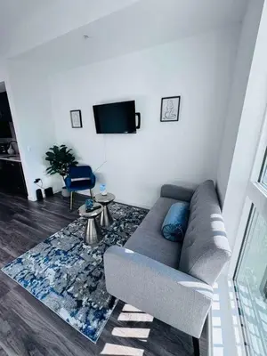 a living room with a couch and a tv at The Central Apartment at Hollywood in Los Angeles