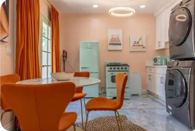 a kitchen with orange chairs and a table in a kitchen at Zen guess house in Los Angeles