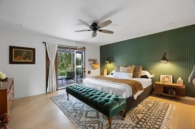 a bedroom with a bed and a green wall at Private Estate with Cottage, Pool & Tennis in Ojai