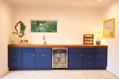 a kitchen with blue cabinets and a refrigerator at Rancho Palomar in Ojai