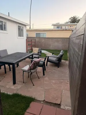a patio with benches and a table and chairs at Beach House in Los Angeles