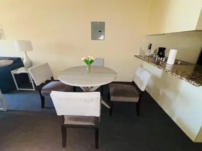 a table and chairs with a vase of flowers on it at 1Bd Prime Westwood Location One Block from UCLA in Los Angeles