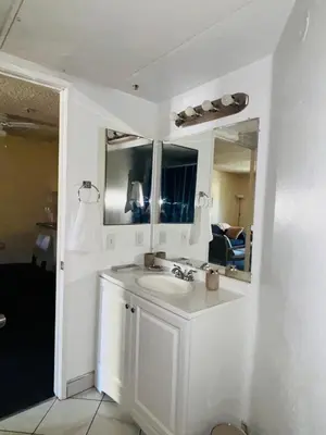 a white bathroom with a sink and a mirror at 1Bd Prime Westwood Location One Block from UCLA in Los Angeles