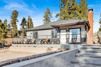 a house with a staircase in front of it at Highland Hideaway at Big Bear | Cozy Cabin w/ Private Hot Tub in Big Bear Lake