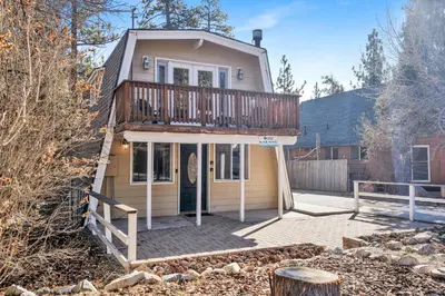 a house with a deck on top of it at The Cave at Big Bear Lake - Adorable Mountain Retreat w/ Hot Tub in Big Bear Lake