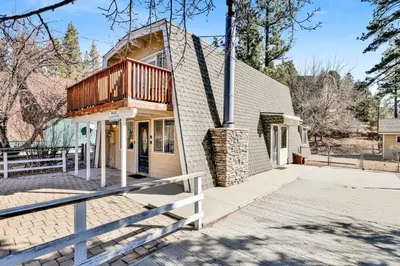 a house with a balcony on top of it at The Cave at Big Bear Lake - Adorable Mountain Retreat w/ Hot Tub in Big Bear Lake
