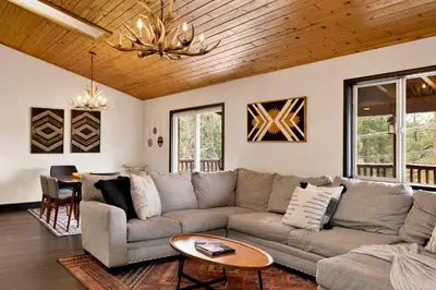 a living room with a couch and a table at Cielos Nest Cabin | Close to Village and Lake with Hot Tub in Big Bear Lake