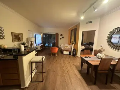 a living room with a table and a dining room at Spacious 1B 1B Pool View Loft Apartment in Marina Del Rey in Los Angeles