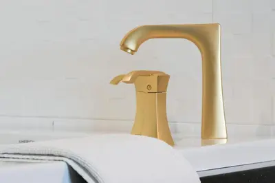 a sink with a faucet and a towel on it at Glen Capri Inn and Suites - Burbank Universal in Glendale