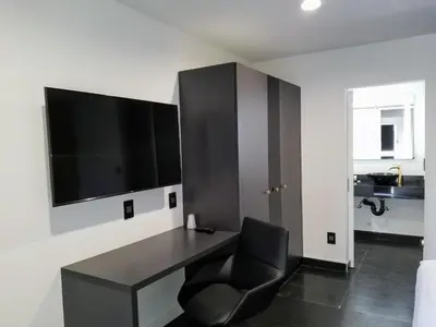 a black desk with a chair in a room at Glen Capri Inn and Suites - Burbank Universal in Glendale