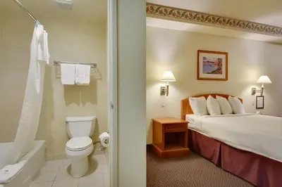 a hotel room with a bed and a bathroom at Vagabond Inn Hacienda Heights in Hacienda Heights
