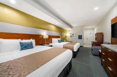 a hotel room with two beds and a television at Best Western Plus Gardena-Los Angeles Inn & Suites in Gardena