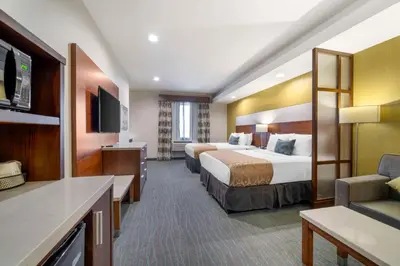 a hotel room with two beds and a television at Best Western Plus Gardena-Los Angeles Inn & Suites in Gardena
