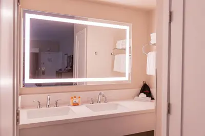 a bathroom with two sinks and a large mirror at Grand Legacy At The Park in Anaheim