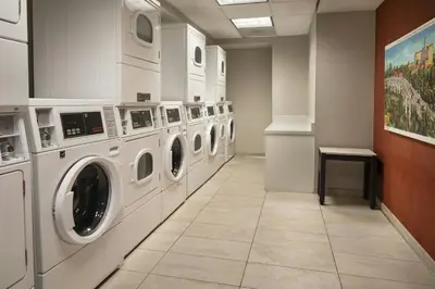 a row of washing machines in a laundry room at Residence Inn by Marriott Los Angeles Pasadena/Old Town in Pasadena