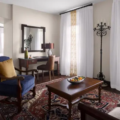a living room with a table and a desk at Plaza la Reina in Los Angeles