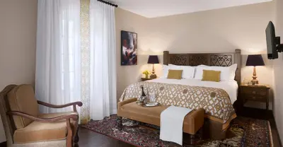 a bedroom with a large bed and a chair at Plaza la Reina in Los Angeles
