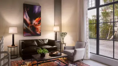 a living room with a couch and a large window at Plaza la Reina in Los Angeles