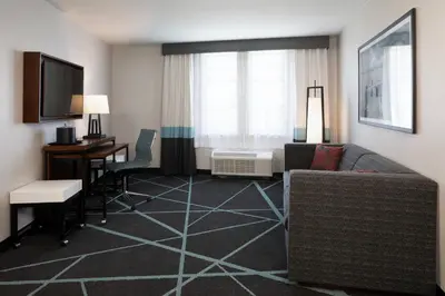 a living room with a couch and a desk at Fairfield Inn & Suites By Marriott Camarillo in Camarillo