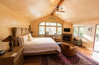 a bedroom with a bed and a ceiling fan at The Emerald Iguana Inn in Ojai
