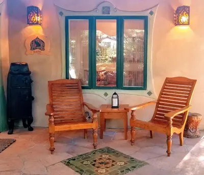 two chairs and a table in a room with a window at The Emerald Iguana Inn in Ojai
